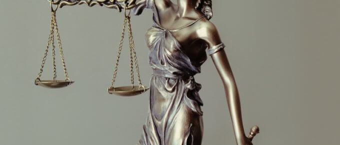 woman in gold dress holding sword figurine